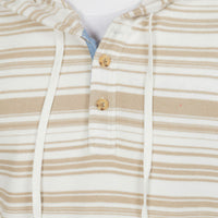 Close-up of a hooded knit top with beige and white horizontal stripes, featuring a buttoned placket with wooden buttons and white drawstrings.