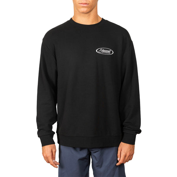 A man wearing a black crewneck sweatshirt with a small white oval 'Society6' logo on the left chest, paired with dark blue pants, against a plain white background.