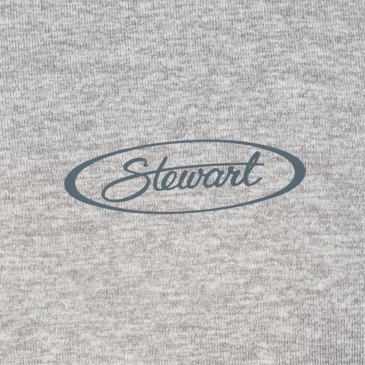 Close-up of a heather gray knit fabric with a dark gray oval logo reading 'Stewart' across the center.