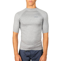 A man wearing a heather gray short-sleeve compression shirt with a small oval logo on the left chest, paired with navy blue shorts, against a plain white background.