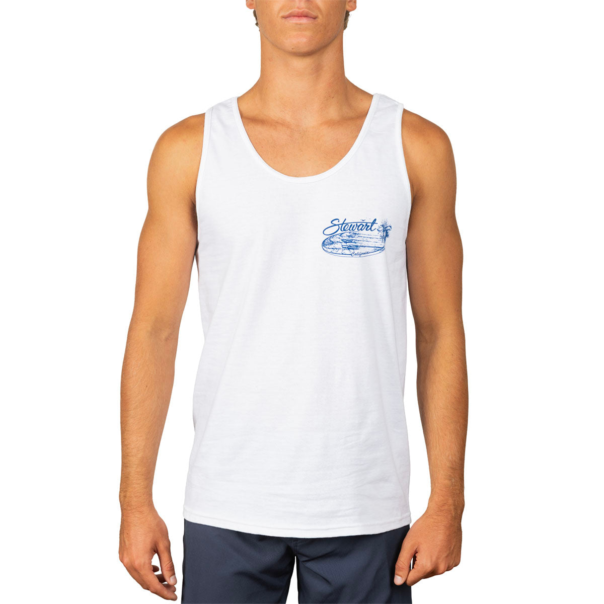 A man wearing a white sleeveless tank top with a blue 'Stewart' graphic on the left chest, paired with navy blue shorts, against a plain white background.