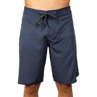 A person wearing navy blue board shorts with a dark gray and black striped drawstring, shown from the waist to mid-thigh against a plain white background.