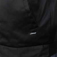 Close-up of a black jacket or overshirt fabric with a small white embroidered script logo reading 'Stewart' near the center.
