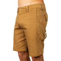 A close-up side view of a person wearing tan cargo shorts against a plain white background.