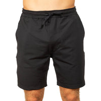 Black athletic shorts with an elastic drawstring waistband, shown on a model against a plain white background.