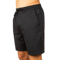 Black athletic shorts with an elastic drawstring waist and side pockets, shown on a model from a side-back angle against a white background.
