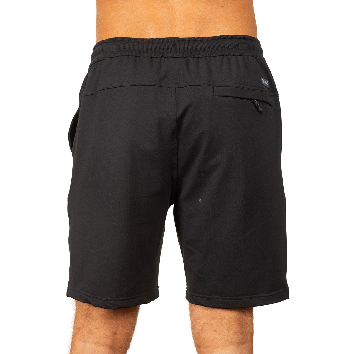 Black athletic shorts with an elastic waistband and zippered side pocket, shown from the back on a model against a white background.