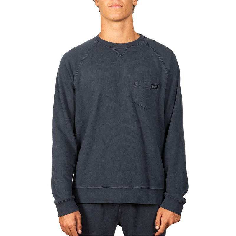 A man wearing a dark charcoal gray crewneck sweatshirt with a chest pocket, shown from the neck down against a plain white background.