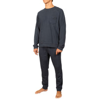 A man wearing a dark charcoal gray long-sleeve crewneck sweatshirt with a chest pocket and matching dark gray sweatpants, shown against a plain white background.
