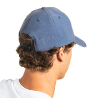 A man shown from the back wearing a heathered blue baseball cap with a black adjustable strap, photographed against a solid white background.
