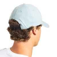 A man shown from the back wearing a light blue baseball cap with a black adjustable strap, on a solid white background.
