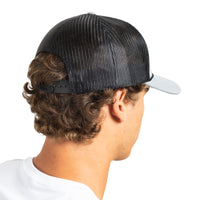 A man shown from the back wearing a black trucker-style cap with a black mesh back and a light gray visor, photographed against a plain white background.