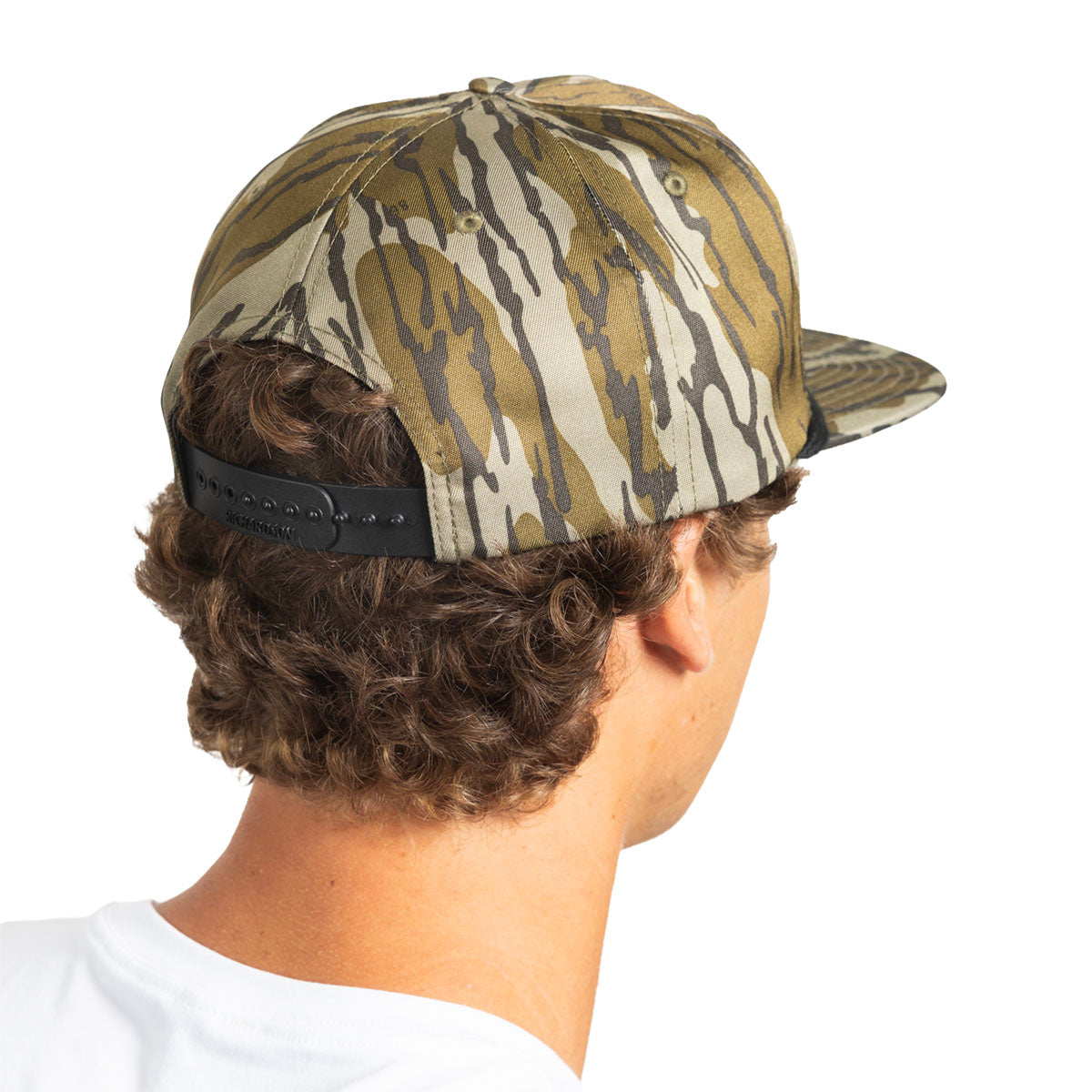Rear view of a man wearing a camouflage baseball cap with a black adjustable strap, isolated on a white background.