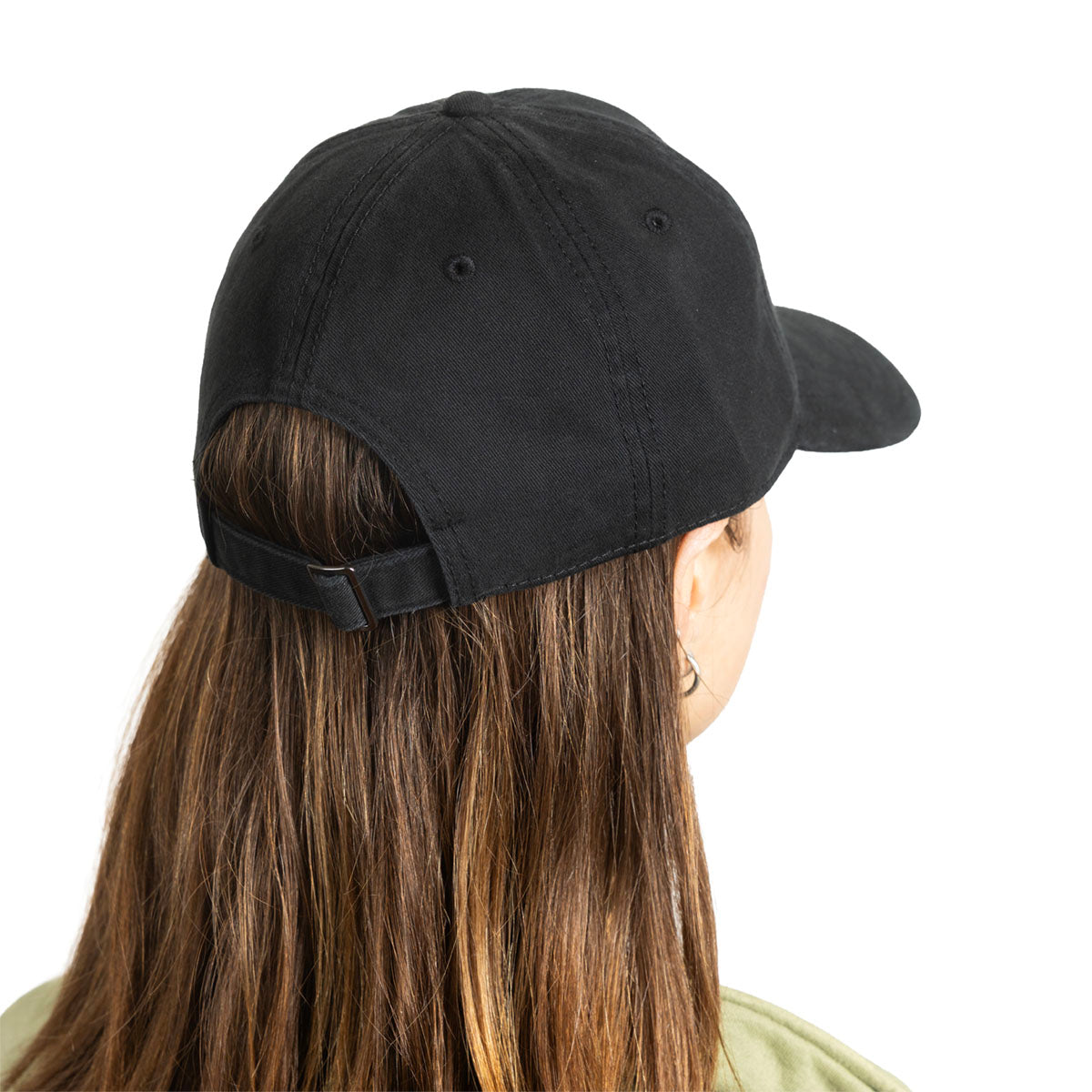 A black baseball cap shown from the back on a model with long brown hair, photographed against a plain white background.