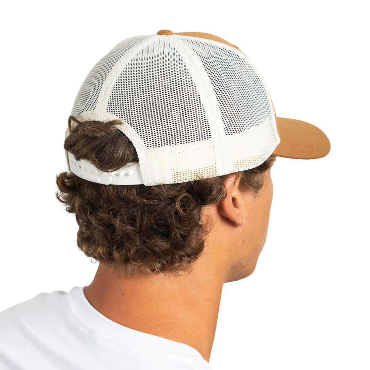 A man shown from the back wearing a white mesh trucker-style cap with a tan crown and visor, photographed against a plain white background.