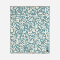 Floral patterned TOWEL with white design on a blue background