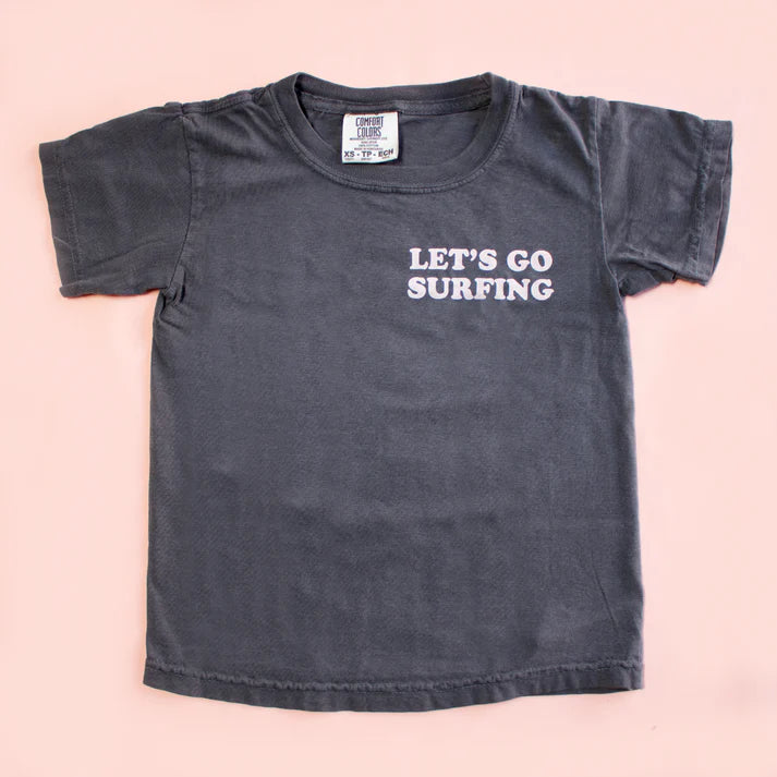 Black t-shirt with 'Let's Go Surfing' text on a pink background