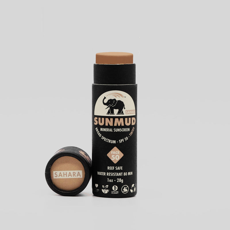 Sunmud mineral sunscreen stick with Sahara shade on a gray background