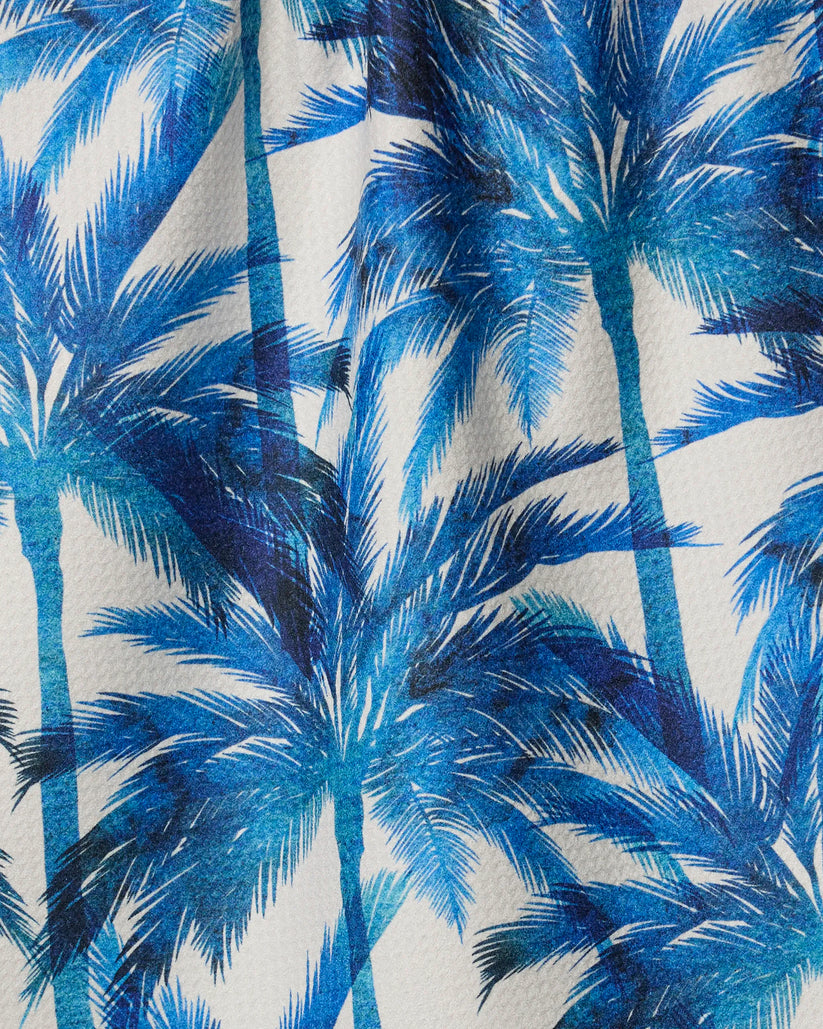 Close-up of blue palm tree pattern on a fabric background