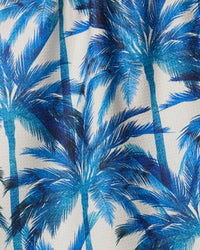 Close-up of blue palm tree pattern on a fabric background
