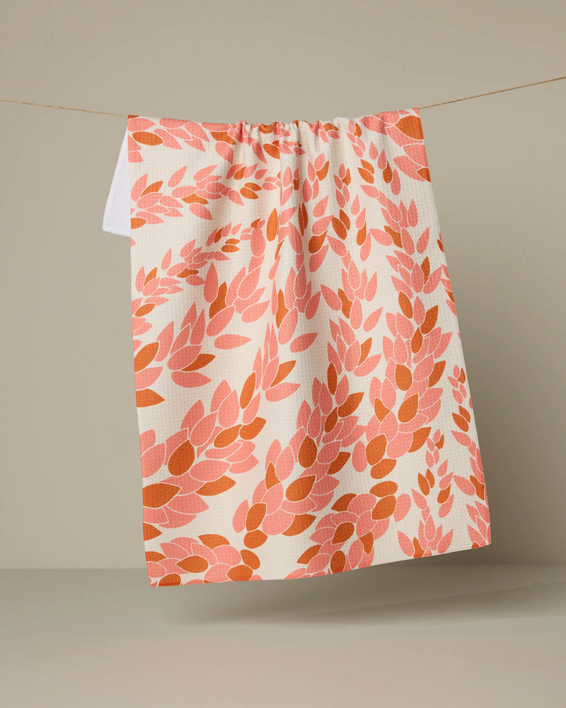 Patterned towel hanging on a line against a beige background