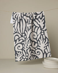 Patterned towel hanging on a line with plates below