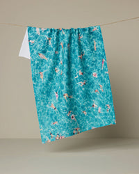 Blue towel with pool and swimmer pattern on a beige background