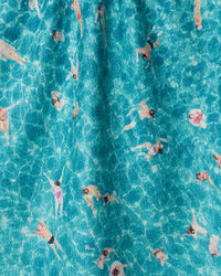 Aerial view of people swimming in a pool with clear blue water.