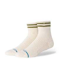 Pair of cream socks with green and blue accents on a white background