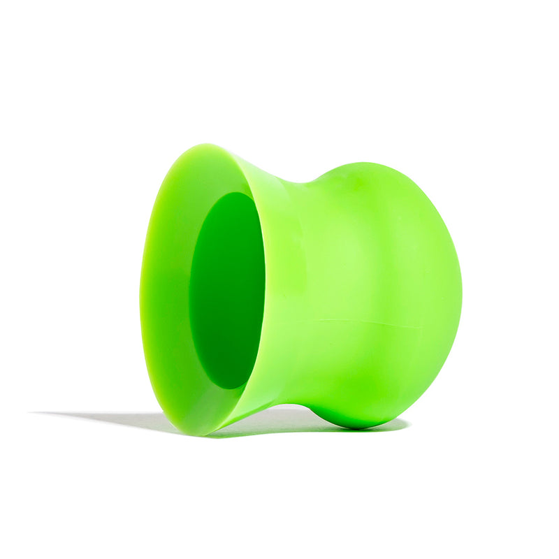 A green wax scraper designed for surfboards, made from recycled plastic and crafted in Australia.