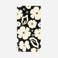 Towel with a black and white floral pattern on a light gray background