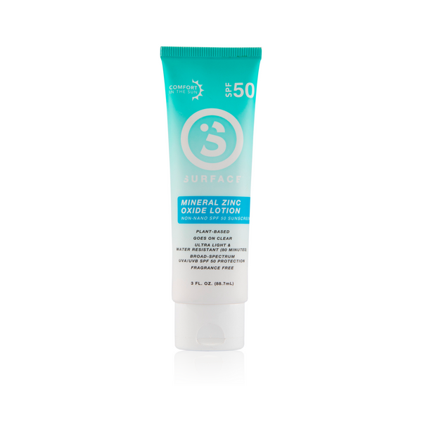 A tube of Surface Mineral SPF50 Sunscreen Lotion with green and white packaging.