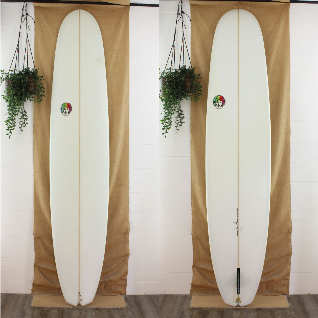 a joe aaron 10 x 24 x 3 1/4 poly longboard with a clear glassjob