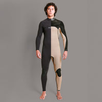 Person wearing a black and beige wetsuit on a gray background