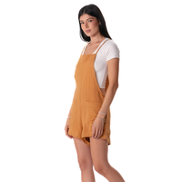 Woman wearing a mustard yellow dress over a white shirt on a white background