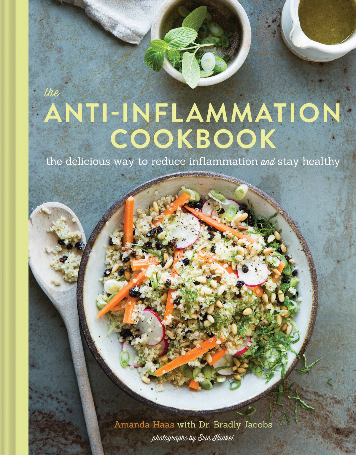 Book cover of 'The Anti-Inflammation Cookbook' with a bowl of salad and ingredients on a rustic background.