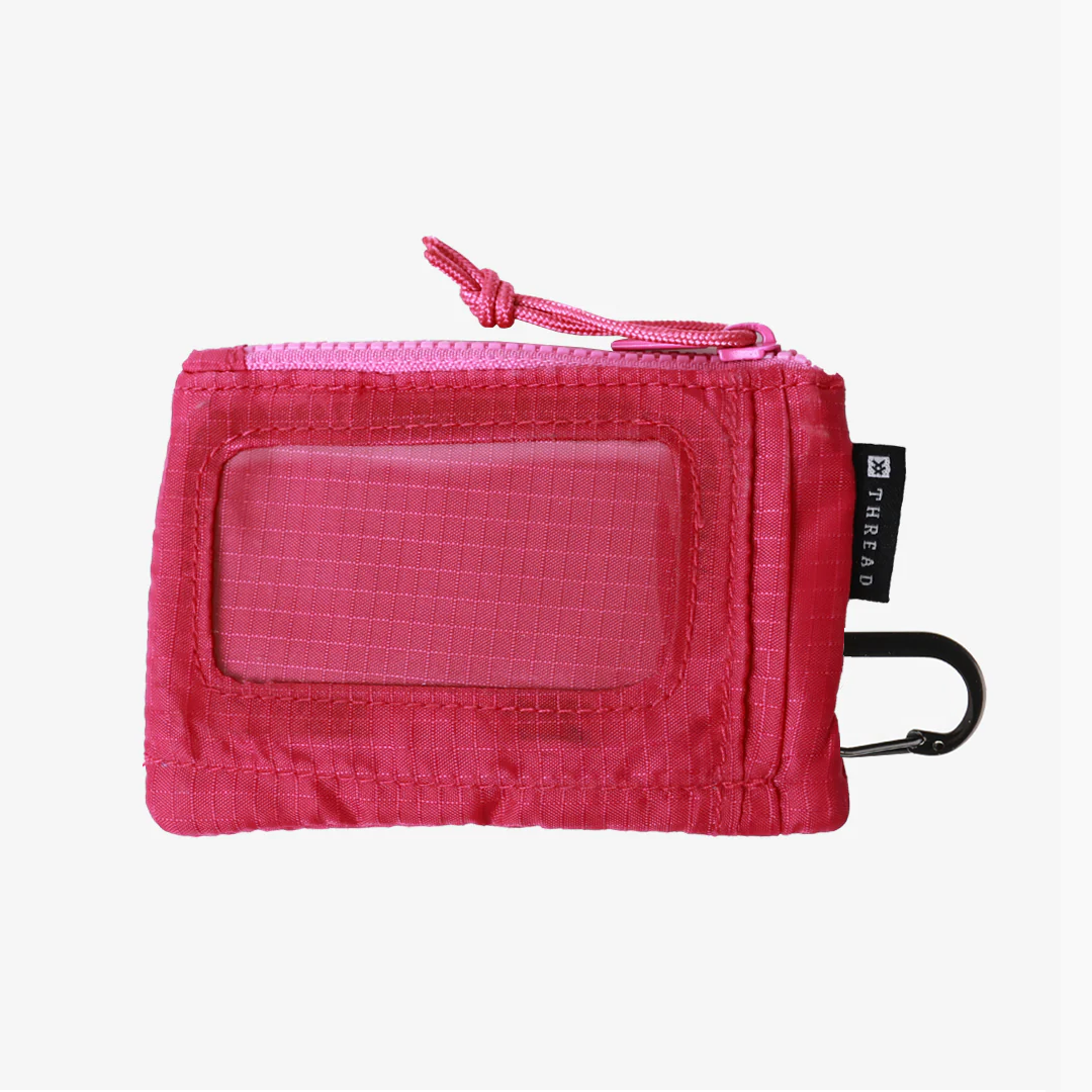 Pink travel pouch with a clear window on a white background