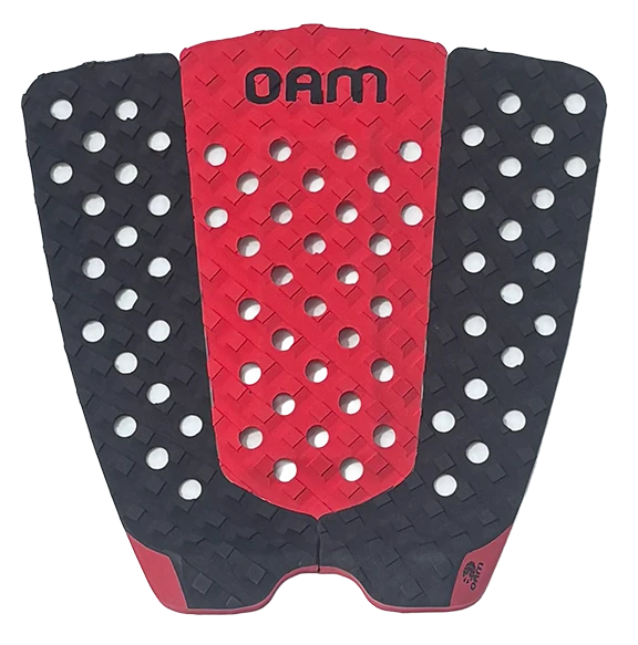 A red and black rubber pad with a diamond- and cross-hatch textured grip, featuring circular cutouts and the brand name 'OAM' printed in black on the red center section.