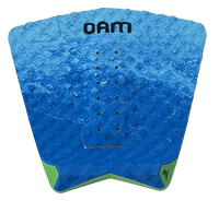 A blue diamond-plate textured surfboard tail pad with green accents at the bottom corners and a black 'OAM' logo printed at the top, shown on a plain white background.