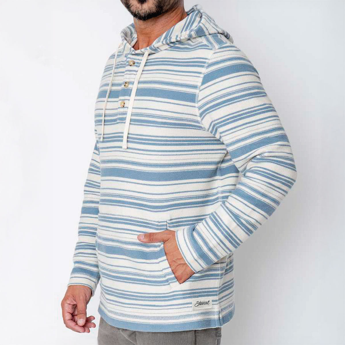 Man wearing a blue and white striped hoodie with a visible brand logo on a white background