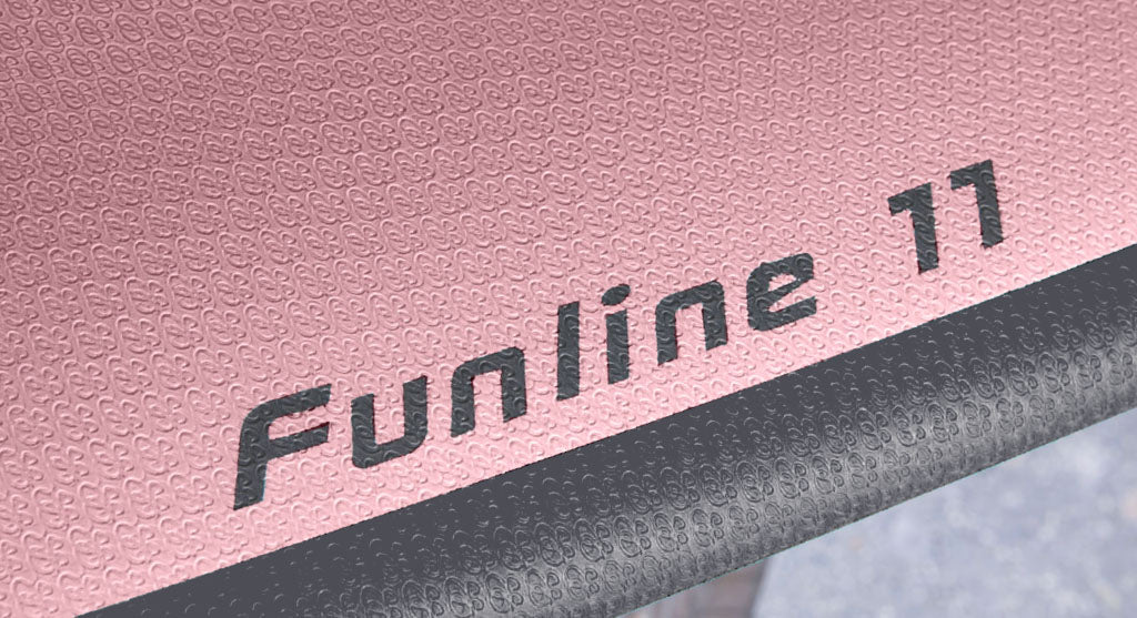 detail view of the light pink and dark grey EVA foam on the deck of the Stewart HydroCush Funline 11 mid length mini longboard soft top surfboard in mauve