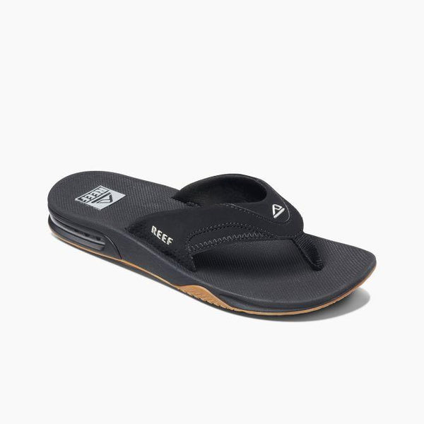 A pair of black REEF men's Fanning sandals with a synthetic nubuck upper and a herringbone rubber outsole.