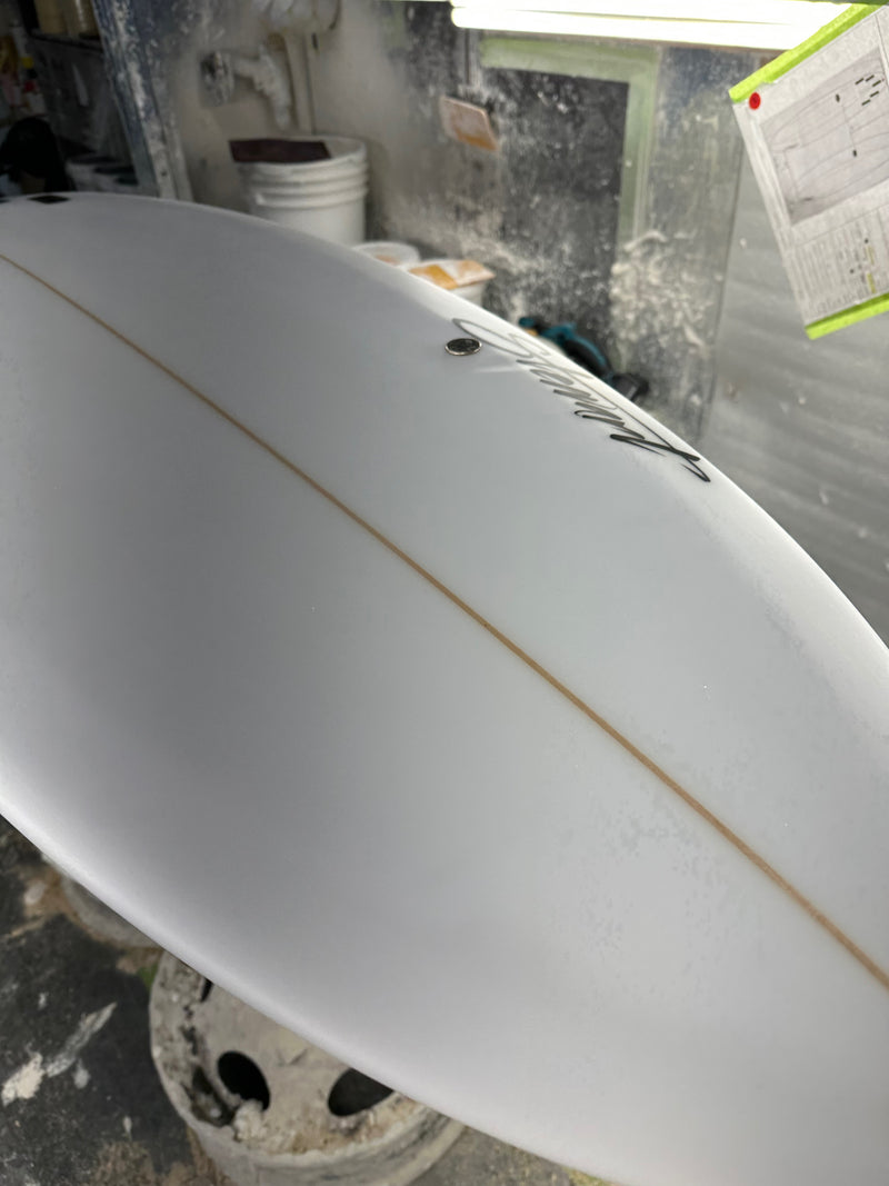 Two minor pressure dings on the bottom of surfboard