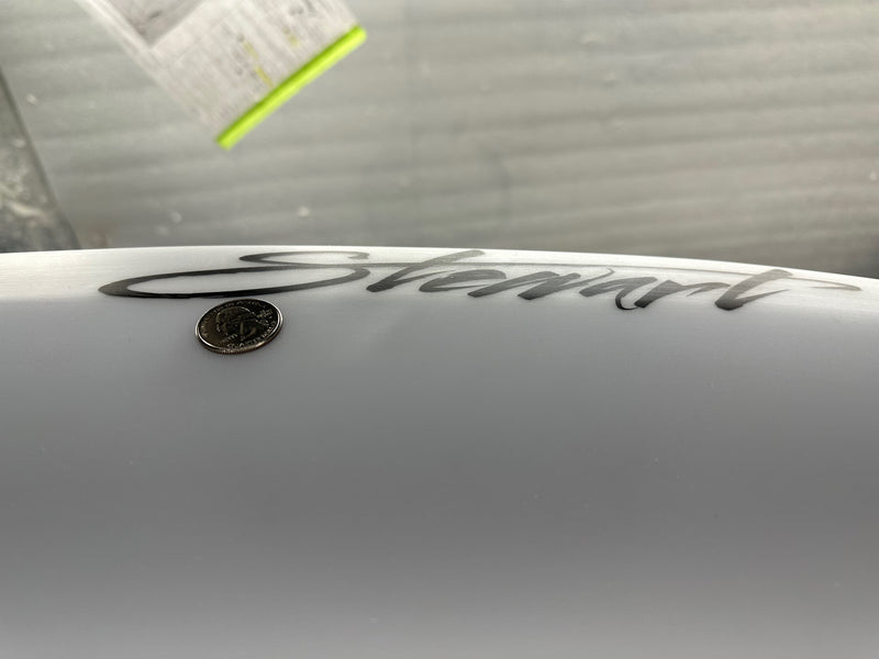 Two minor pressure dings on the bottom of surfboard
