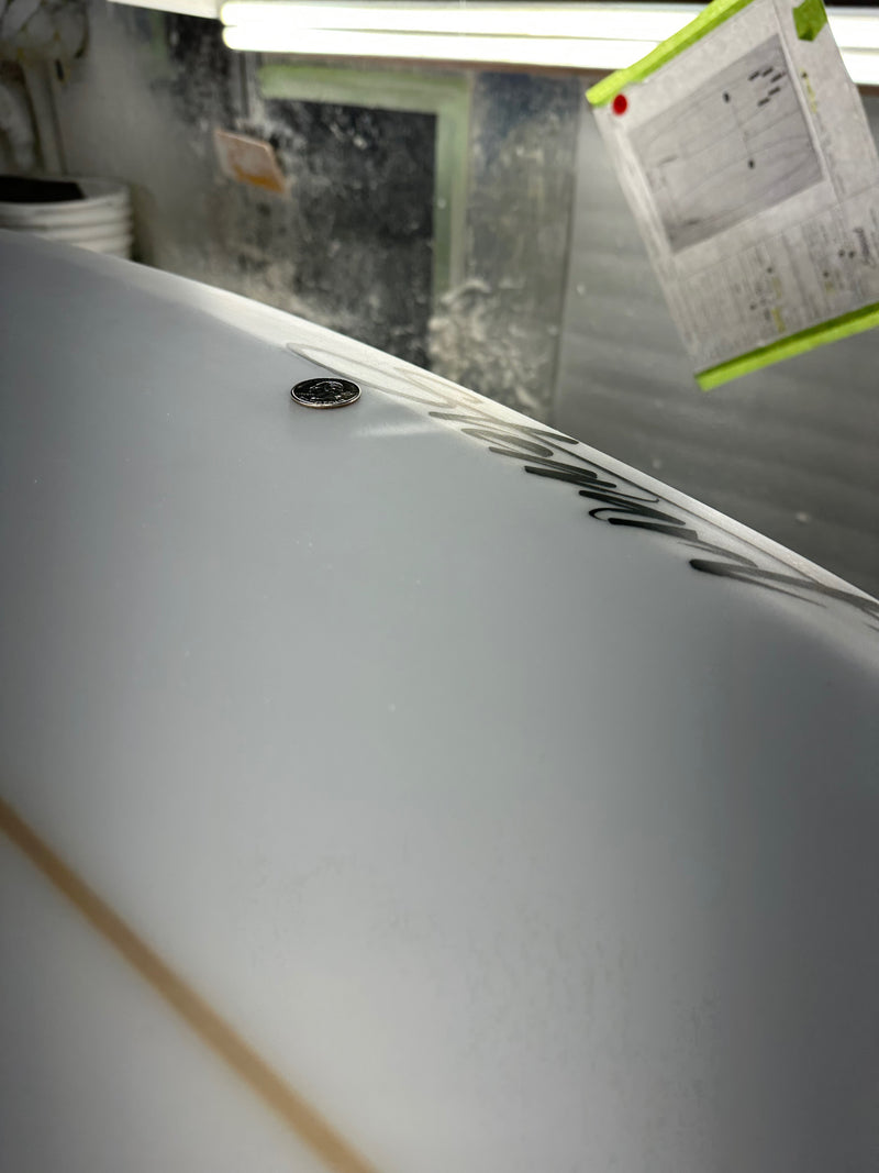 Two minor pressure dings on the bottom of surfboard