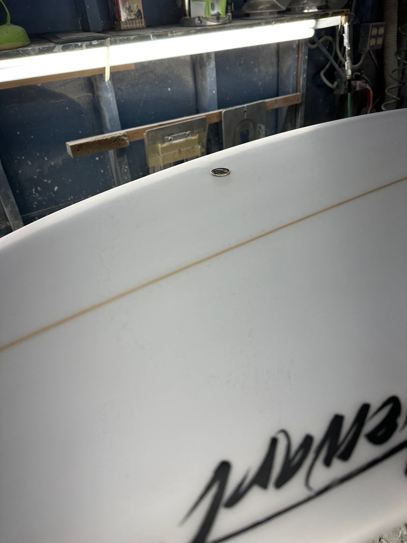 Two minor pressure dings on the bottom of surfboard