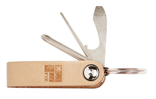 A surf keychain with leather and polished metal finishes, featuring a hex key, philips screwdriver, and an alloy bottle opener.