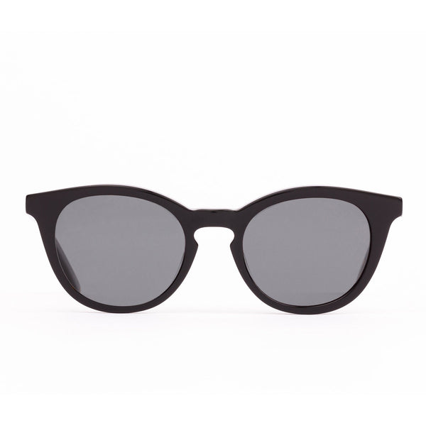 A pair of round full frame sunglasses with a dark color lens and frame.
