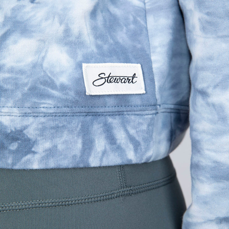 Detail view of Stewart woven label on crop hoody on model